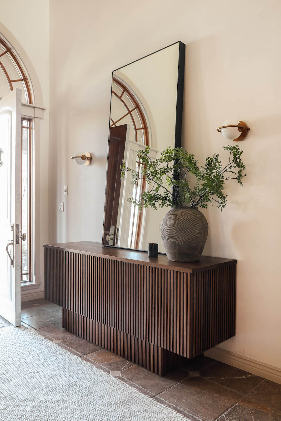 entryway with oversized mirro and credenza