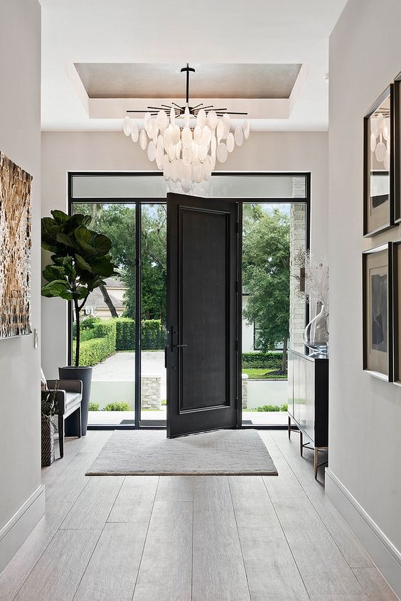 gorgeous entryway with pendant lighting and dark door