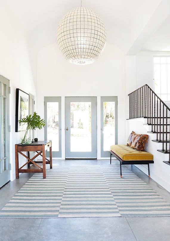 grand entryway with oversized pendant lighting