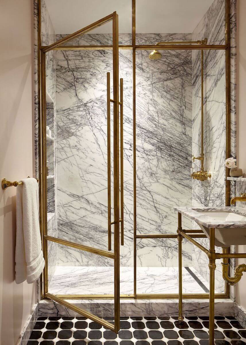 marble walk in shower brass details