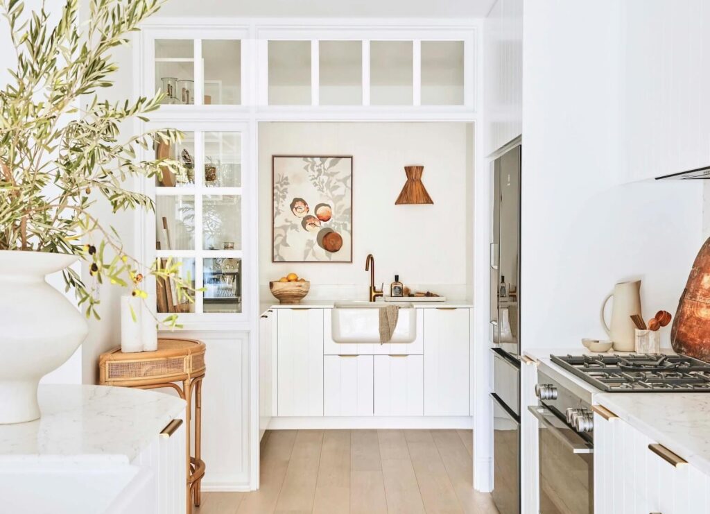 white butlers pantry with windows adjacent to kitchen