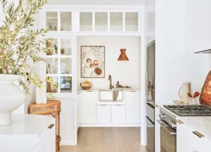 white butlers pantry with windows adjacent to kitchen